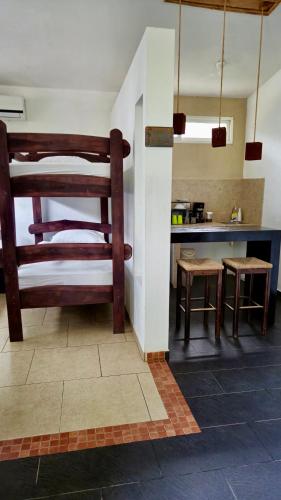 a kitchen with a bunk bed and a table at Eco del Mar in La Libertad