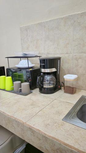a kitchen counter with a toaster and a coffee maker at Eco del Mar in La Libertad