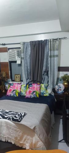 a bedroom with a bed with curtains on it at Florida sun condo in Dasmariñas