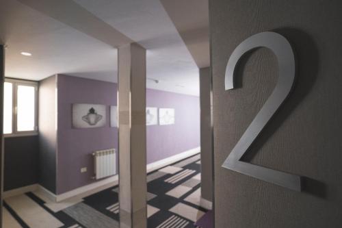 a room with purple walls and a hallway with a door at Hotel Tolosa in Puerto Madryn