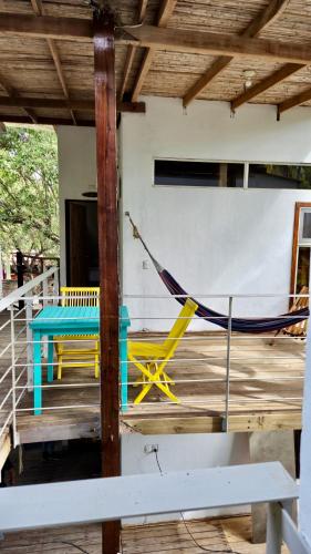a hammock on the deck of a house at Eco del Mar in La Libertad