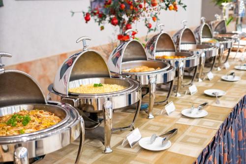 a row of trays of food on a table at DIC Star Landmark in Vung Tau