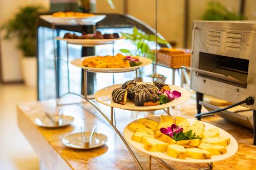 a table with three tiers of plates of food at DIC Star Landmark in Vung Tau