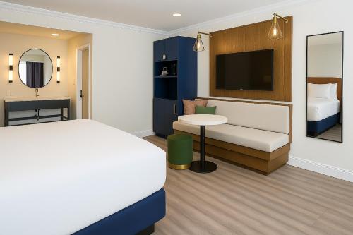 a hotel room with a bed and a tv at The Woodrose- NEWLY RENOVATED in Willits