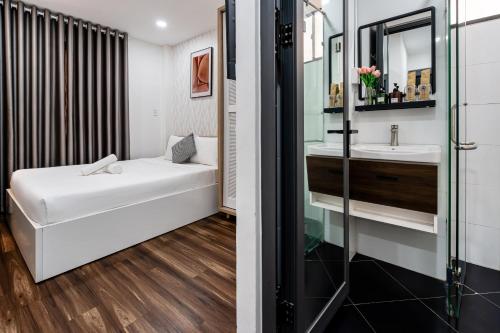 a bathroom with a sink and a mirror at Lotus Lalala Inn Hotel in Ho Chi Minh City