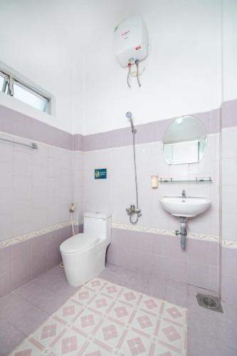 a bathroom with a toilet and a sink at Vicky's House- Back Room in Nha Trang