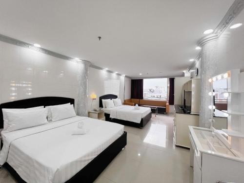 a hotel room with two beds and a television at K&T Hotel - Center SaiGon in Ho Chi Minh City