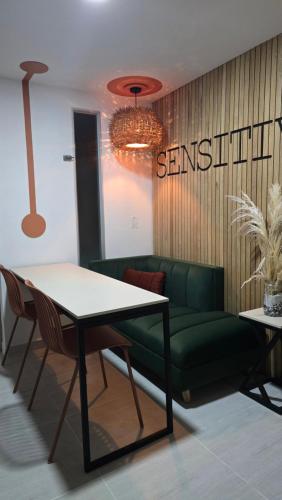 a living room with a green couch and a table at Sensitivo Home in Envigado