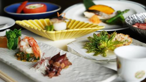 a table with several plates of food on it at Hotel Kikori in Hida