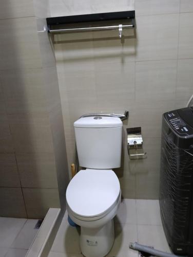 a bathroom with a white toilet and a trash can at Shore residences tower D in Manila