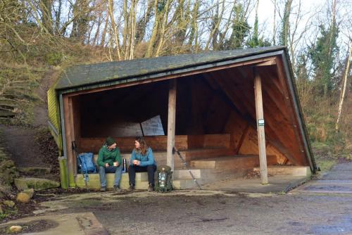 two people sitting inside of a wooden shed at Apple Blossom Studio - near Rønne and Beach in Rønne
