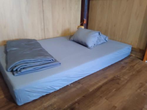 a bed with two pillows on it in a room at Vũ Gia Homestay in Ấp Bình Thạnh