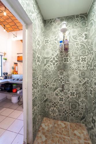 a bathroom with a shower with a tile wall at Best Location in Sayulita - Walk to Everything in Sayulita