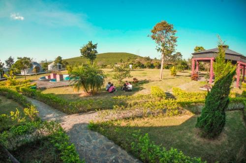 a group of people sitting in a park at Emopea Moc Chau in Mộc Châu