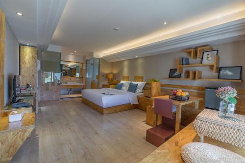 a hotel room with a bed and a living room at Dali Shuanglang seven-room sea view hotel in Dali Shuanglang