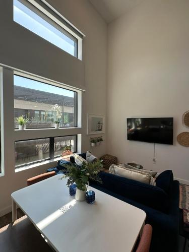 a living room with a table and a large window at Austin Stylish Studio in Austin