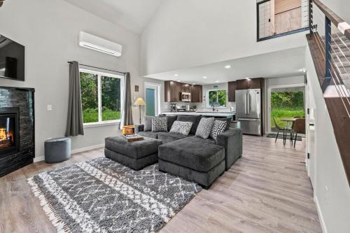a living room with a couch and a fireplace at Rainier Cabin with Fireplace-WiFi-Yard-Meadow Views in Ashford