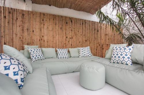 a living room with a white couch and pillows at Luxurious 7BR Villa in Mui Ne with Private Swimming Pool in Ấp Thiện Phước