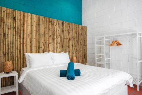 a white bed with a blue elephant sitting on it at Luxurious 7BR Villa in Mui Ne with Private Swimming Pool in Ấp Thiện Phước
