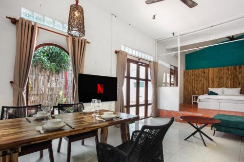 a dining room with a wooden table and chairs at Luxurious 7BR Villa in Mui Ne with Private Swimming Pool in Ấp Thiện Phước