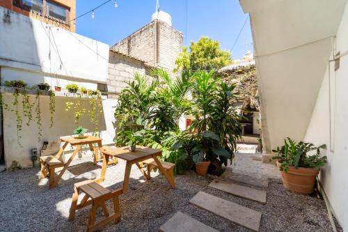 a patio with two tables and some plants at Best Location in Sayulita - Walk to Everything in Sayulita