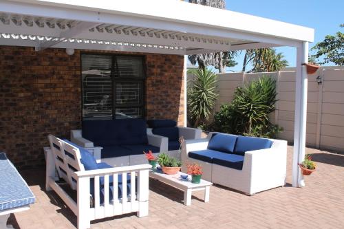 a patio with two chairs and a pavilion at Quest Bed And Breakfast in Melkbosstrand