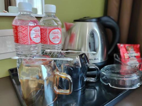 two bottles of water sitting on top of a counter at LI HUA HOTEL , BINTULU SENTRAL in Bintulu