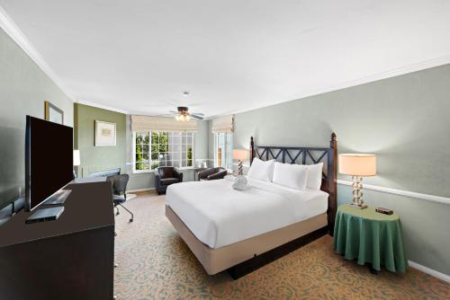 a hotel room with a bed and a television at The Morgan Hotel San Simeon in San Simeon