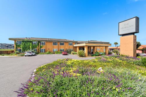 a hotel with a sign in front of a parking lot at The Morgan Hotel San Simeon in San Simeon