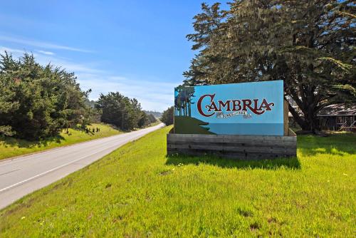 a sign in the grass next to a road at The Morgan Hotel San Simeon in San Simeon