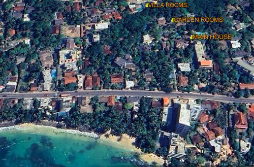 an aerial view of a beach with houses and a road at The Spice House Mirissa in Mirissa