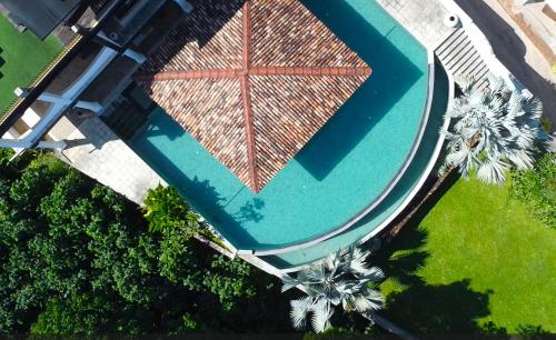 an overhead view of a swimming pool with palm trees at The Spice House Mirissa in Mirissa
