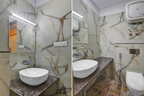 a bathroom with two sinks and a mirror at Super Collection O Hotel Blueline in Juhi Bari