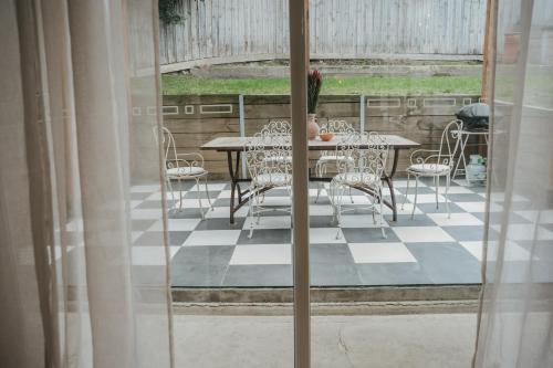 a patio with a table and chairs on a porch at Harker House in Healesville