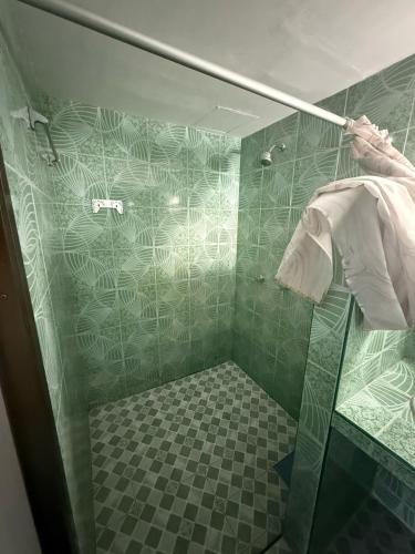 a bathroom with a shower with a glass door at Karon Cove at Seabreeze Inn in Karon Beach