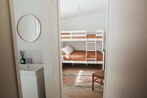 a small bedroom with a bunk bed and a mirror at Harker House in Healesville