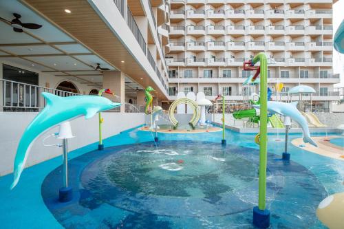 a pool with a water park in a hotel at Jomtien Thani Hotel in Jomtien Beach