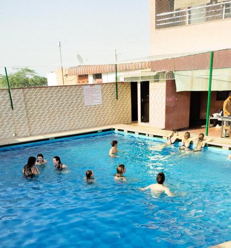a group of people swimming in a swimming pool at Apple Resort & Restaurant in Jodhpur
