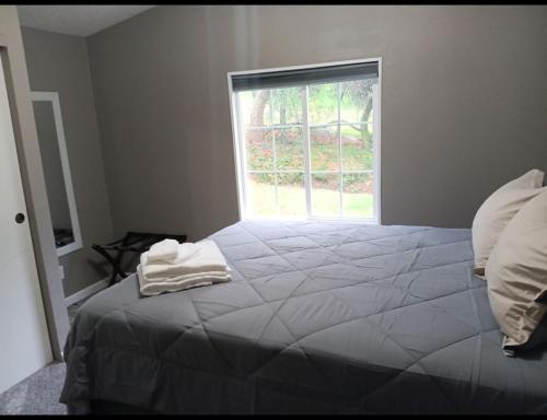 a bedroom with a large bed with a window at Sequoia Eagle Nest in Three Rivers