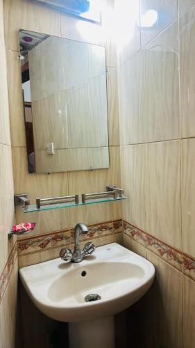 a bathroom with a sink and a mirror at Hotel Olio Dream Heaven in Dhaka