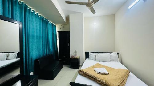 a small room with a bed and a chair at Hotel Olio Dream Heaven in Dhaka