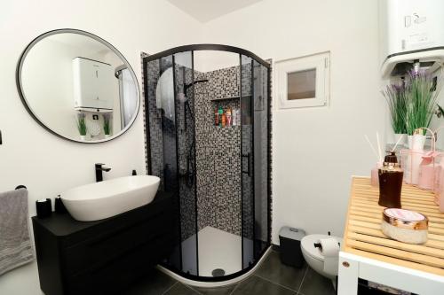 a bathroom with a shower with a sink and a mirror at Fidelis Apartment - Walk to the Beach in Minutes in Novi Vinodolski