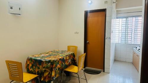 a room with a table and chairs and a door at Hotel Olio Dream Heaven in Dhaka