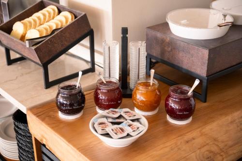 a table with jam and a plate of food on it at Hotel Coste in Limone sul Garda