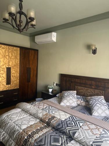 a bedroom with a large bed and a fan at room inside villa in Cairo