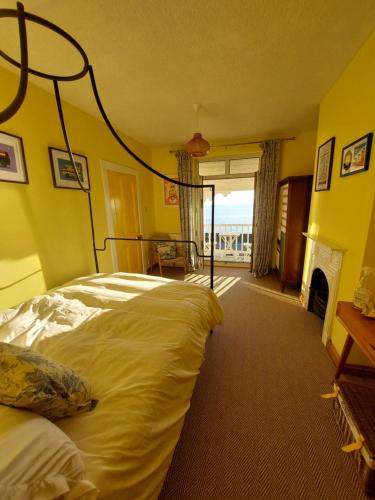 a hotel room with a bed and a fireplace at Velo Club Mumbles in Oystermouth