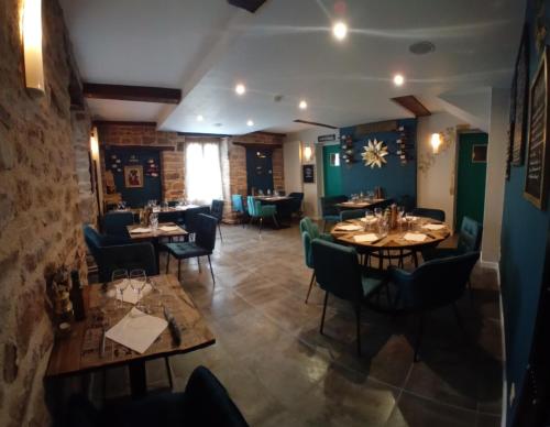 a restaurant with tables and chairs in a room at Au bord de l'eau Salles sur Cerou in Salles
