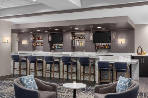 a bar in a hotel room with chairs and a counter at DoubleTree by Hilton Las Vegas Airport in Las Vegas