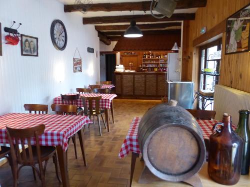 un restaurant avec des tables et des chaises rouges et blanches dans l'établissement Le Cabanon du camping, à Bannes