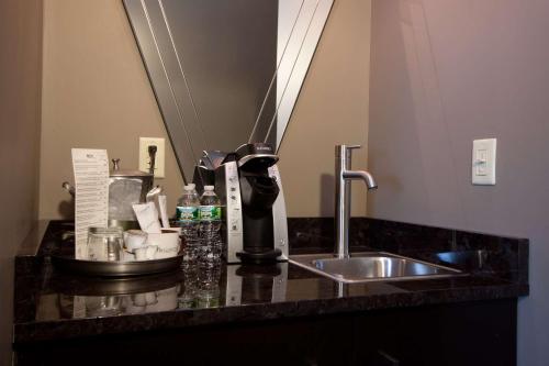 a kitchen counter with a sink and a coffee maker at The Giacomo, an Ascend Collection Hotel in Niagara Falls